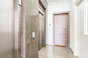 a hallway with a shower with a glass door at YAMAS Urban Living Pool Penthouse Marvel in Limassol