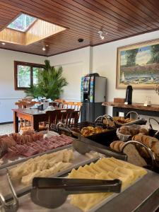 a buffet with many different types of food on display at Kastel Pedra Bonita in Petrópolis