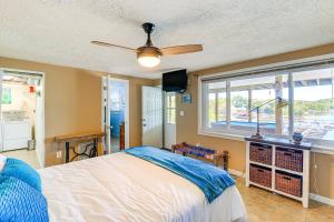 a bedroom with a bed with a ceiling fan and a window at Kingsport Boone Lake Hideaway with Deck and Views! in Kingsport