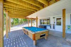 a pool table sitting on the porch of a house at Kingsport Boone Lake Hideaway with Deck and Views! in Kingsport