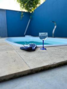 a pair of shoes and a wine glass on a sidewalk at Tiny Lagoa in Jijoca de Jericoacoara +3 photos