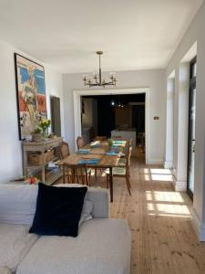 a living room with a table and a dining room at Beach House in Swanage +27 photos