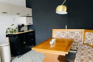 a kitchen with a wooden table and a counter at Ferienhaus mit Seeblick in Templin