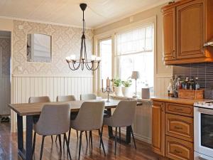 a kitchen with a dining room table and chairs at Holiday home LYSEKIL XXXII in Lysekil