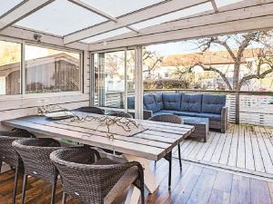 a patio with a wooden table and chairs at Holiday home LYSEKIL XXXII in Lysekil