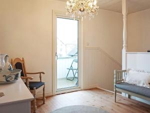 a living room with a chandelier and a sliding glass door at Holiday home LYSEKIL XXXII in Lysekil