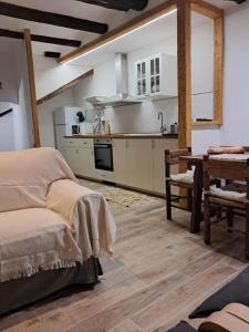 a kitchen with a bed and a table in a room at Lo Cremallé in Valderrobres