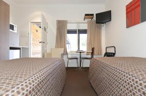 Ένα ή περισσότερα κρεβάτια σε δωμάτιο στο Chalambar Motel