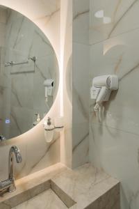 y baño con ducha y lavamanos. en In Town Boutique HOTEL, en Pristina