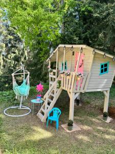 a play house with a slide and a swing at Chata Kokava Línia tour 2 in Kokava na Rimavica