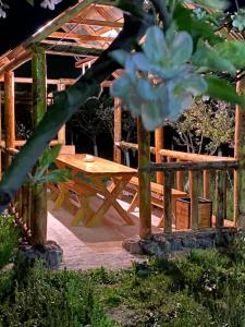 a wooden picnic table in front of a wooden gazebo at Gyumrva Tun in Gyumri