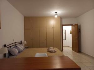 a bedroom with a bed and a wooden table at Sophie's Sunny Spot 3 in Yéfira
