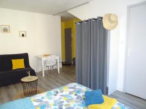 a room with a bed and a couch and a table at Le Notre Dame in Boulogne-sur-Mer