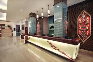 a lobby with a reception desk in a building at Mercure Pontianak City Center in Pontianak