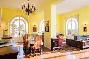 a dining room with a table and a couch at Il patio di Anghiari - Bella vista e relax in Anghiari +45 photos