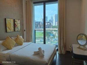 a hotel room with a bed with a large window at Opus Residence Kuala Lumpur by KL Suite in Kuala Lumpur