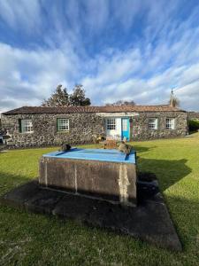 a stone house with a swimming pool in the yard at Casa do Cacto - 1 Bedroom Cosy Flat in Madalena
