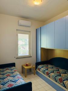 En eller flere senge i et værelse på Villa De Simone