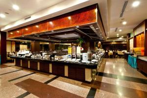 a restaurant with a buffet line in a hotel at Grand Pacific Sovereign Resort & Spa in Cha Am