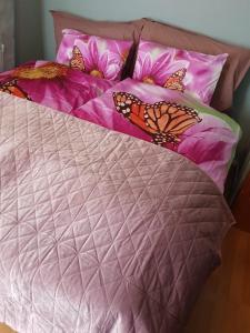 a bed with butterflies sitting on top of it at George&K Apartament in Larvik