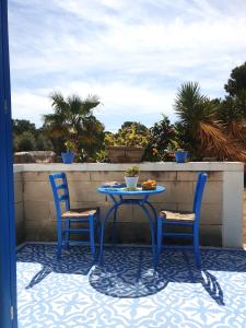 a table and two chairs sitting on a patio at Dimora Quattro Vanelle in Favignana