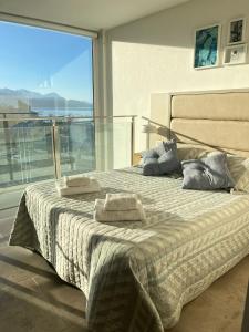 a bedroom with a bed with two pillows on it at Miras Apartment Ushuaia in Ushuaia
