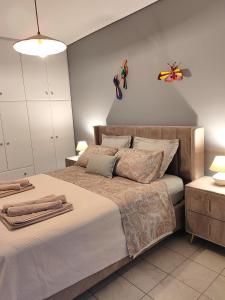 a bedroom with a large bed with towels on it at The cozy seaside apartment in Nafpaktos