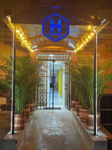 an entrance to a building with plants and lights at Hotel Boutique San Joaquin Plaza in Medellín