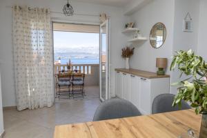 Holiday house Mila في بوستيرا: مطبخ وغرفة طعام مطلة على المحيط