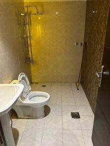 a bathroom with a toilet and a sink at كيان حراء للشقق المخدومة- Kayan Hiraa Serviced Apartments in Jeddah