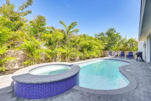a swimming pool with avisorvisor around it at Marco Island Home with Pool and Hot Tub Near Beaches! in Marco Island