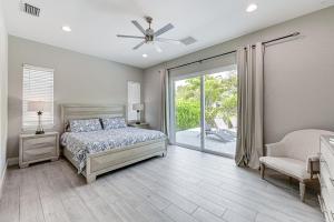 a bedroom with a bed and a sliding glass door at Marco Island Home with Pool and Hot Tub Near Beaches! in Marco Island +27 photos