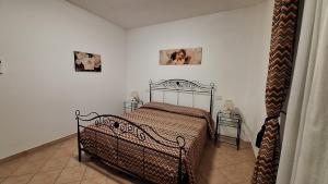 a bedroom with a bed and two pictures on the wall at Agriturismo Tre Cerri di Zanaboni Franca in Orbetello