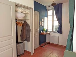 a hallway with a closet and a window at AC - Quiet - Le Colibri, Bright Duplex in Avignon