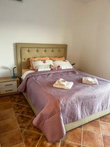 a bedroom with a bed with two towels on it at Villa Tre Tri in Herceg-Novi +9 photos