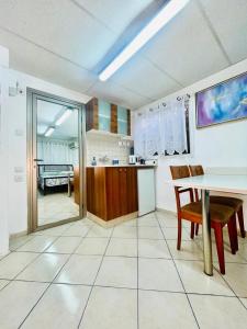 a kitchen with a table and a dining room at Eilat Beach House in Eilat