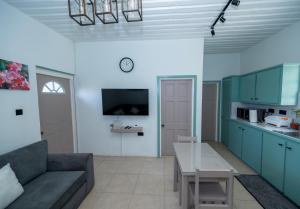 a living room with a couch and a table at SOHI Villa in Gros Islet