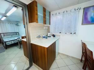 a small kitchen with a sink and a table at Eilat Beach House in Eilat +18 photos