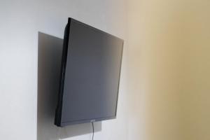 a flat screen tv hanging on a wall at Sea in Adelianos Kampos