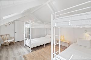 a bedroom with two bunk beds and a desk at Outbound Stowe in Stowe