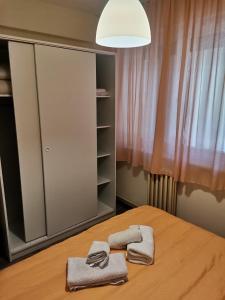 a bedroom with a bed with two towels on it at DiV 3 in Novi Sad