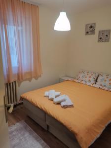 a bedroom with a bed with towels on it at DiV 3 in Novi Sad
