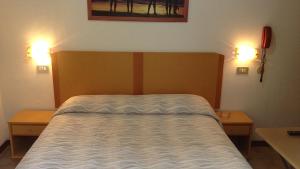 Postel nebo postele na pokoji v ubytování Hotel La Caravella