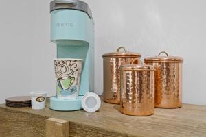 a row of copper containers sitting on a wooden shelf at The Benton at The Rise Retreat (L2) in Hood