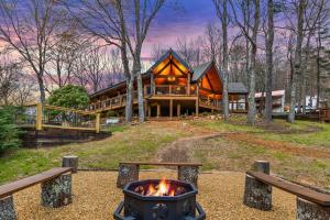 a fire pit in front of a log house at The Benton at The Rise Retreat (L2) in Hood +12 photos