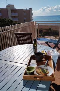 a tray with a plate of food on a table at Apartamento Terraza Mar El Azul in Santa Susanna
