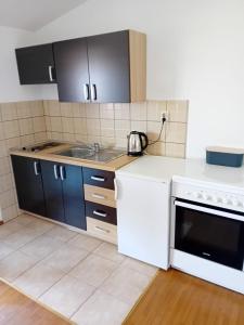 a kitchen with a sink and a stove at Apartman Peace 3 in Međugorje