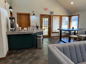 a kitchen with a bar and a table and chairs at Arbor Suites at the Mall in Springfield
