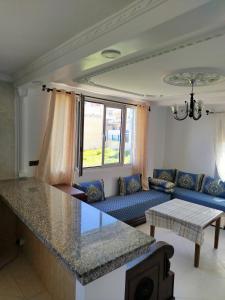 a living room with a couch and a table at Apartment Corniche Ksar Sgher in Ksar es Sghir
