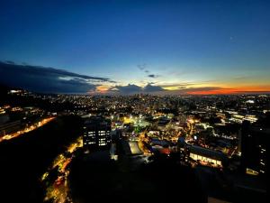 a view of a city at night with lights at BH com Vista Imbatível! in Belo Horizonte